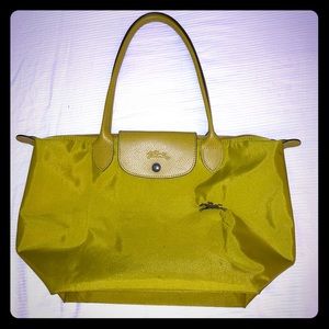 Longchamp mustard yellow/green medium-sized purse.